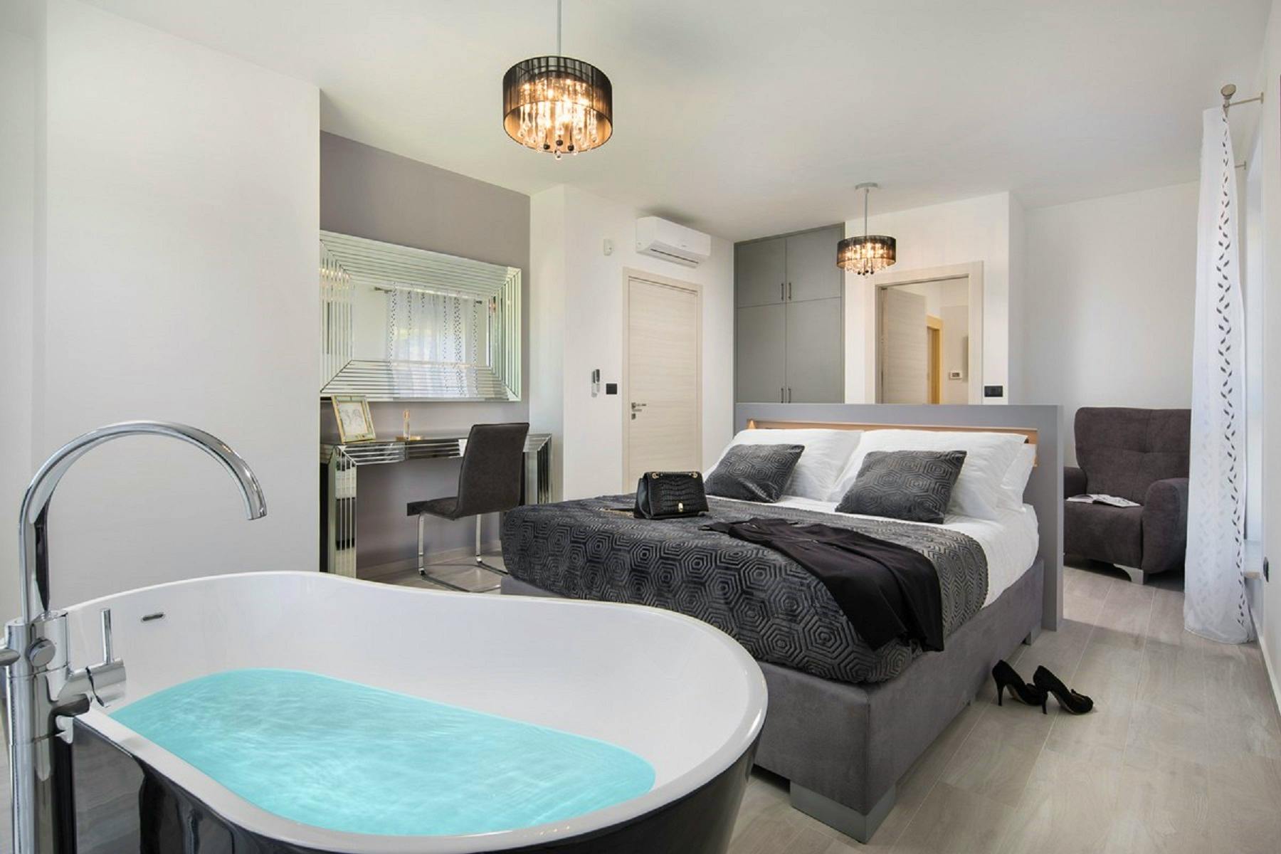 Furnished bedroom with a bathtub