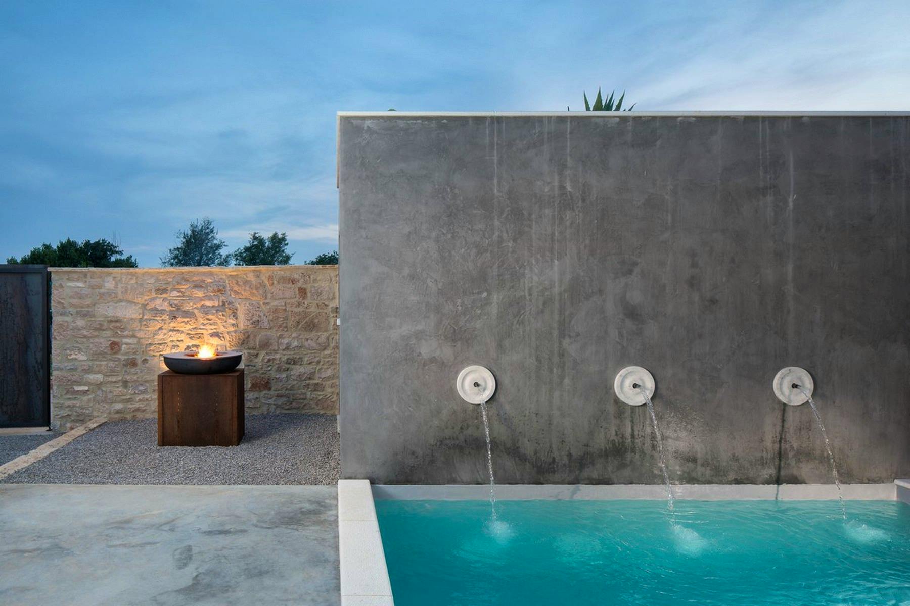 Gorgeous swimming pool surrounded by stone