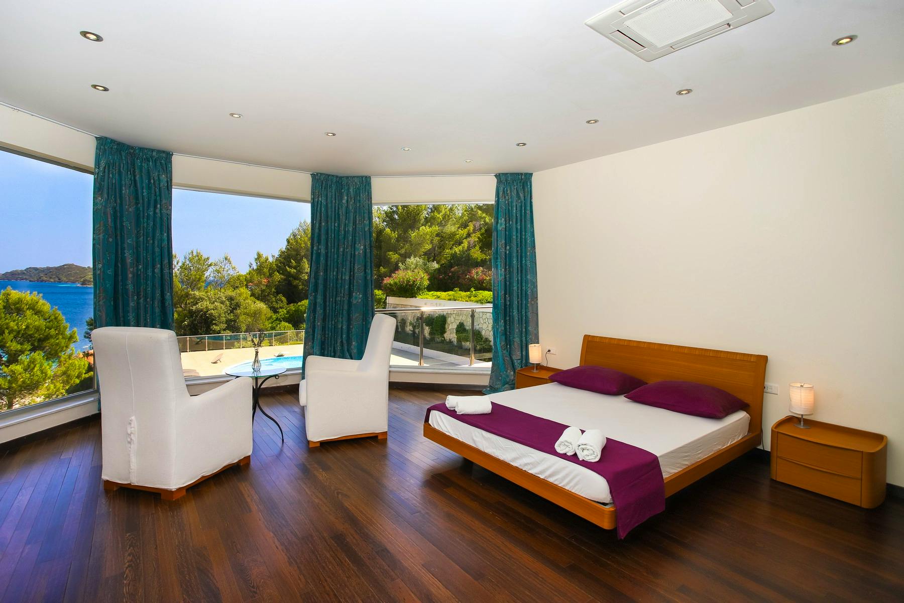 Spacious bedroom overlooking the pool and sea
