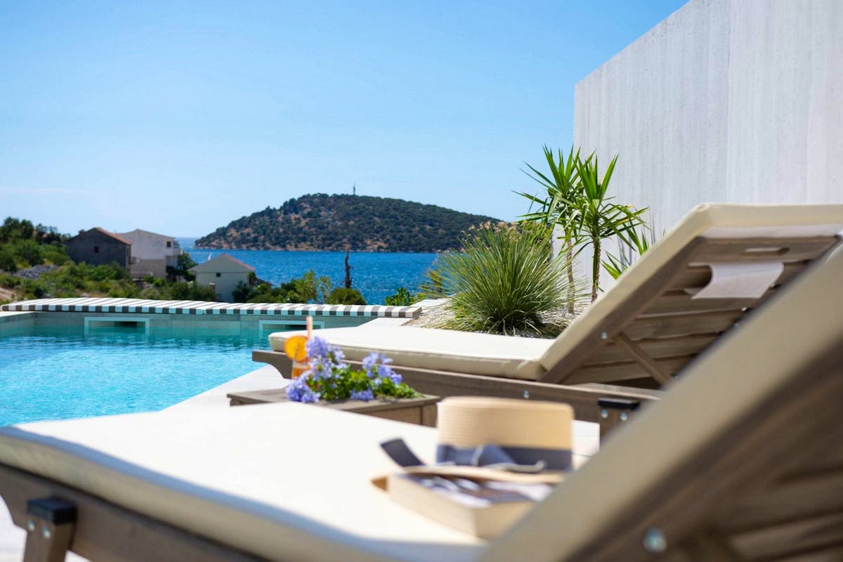 Heated swimming pool with sundeck overlooking the sea