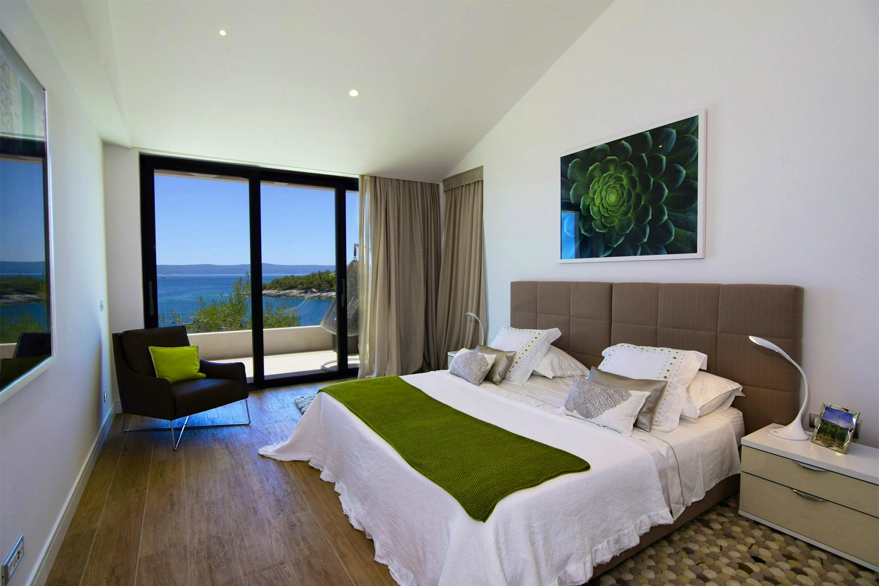 Large bedroom providing open sea view