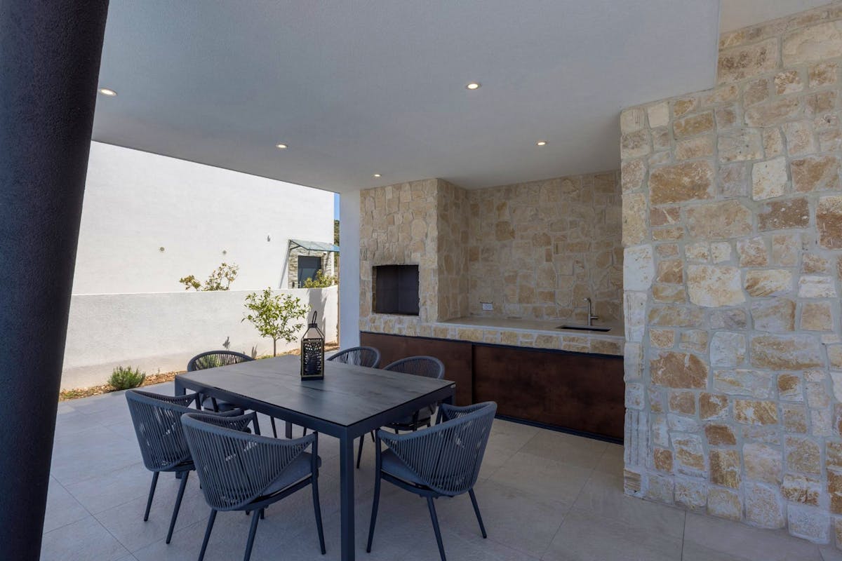 Outdoor grill area with dining table 