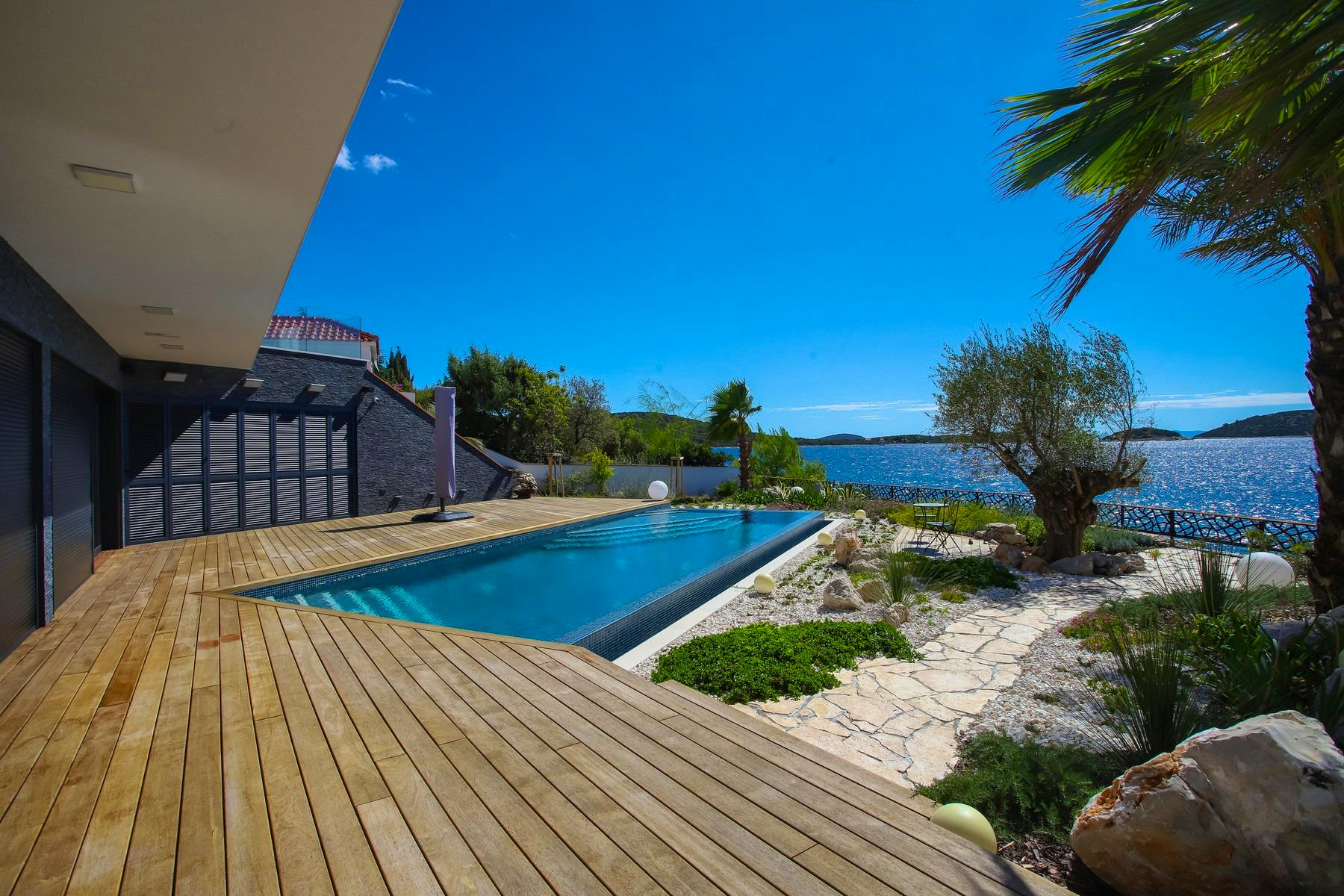 Spacious terrace with heated swimming pool and open sea view
