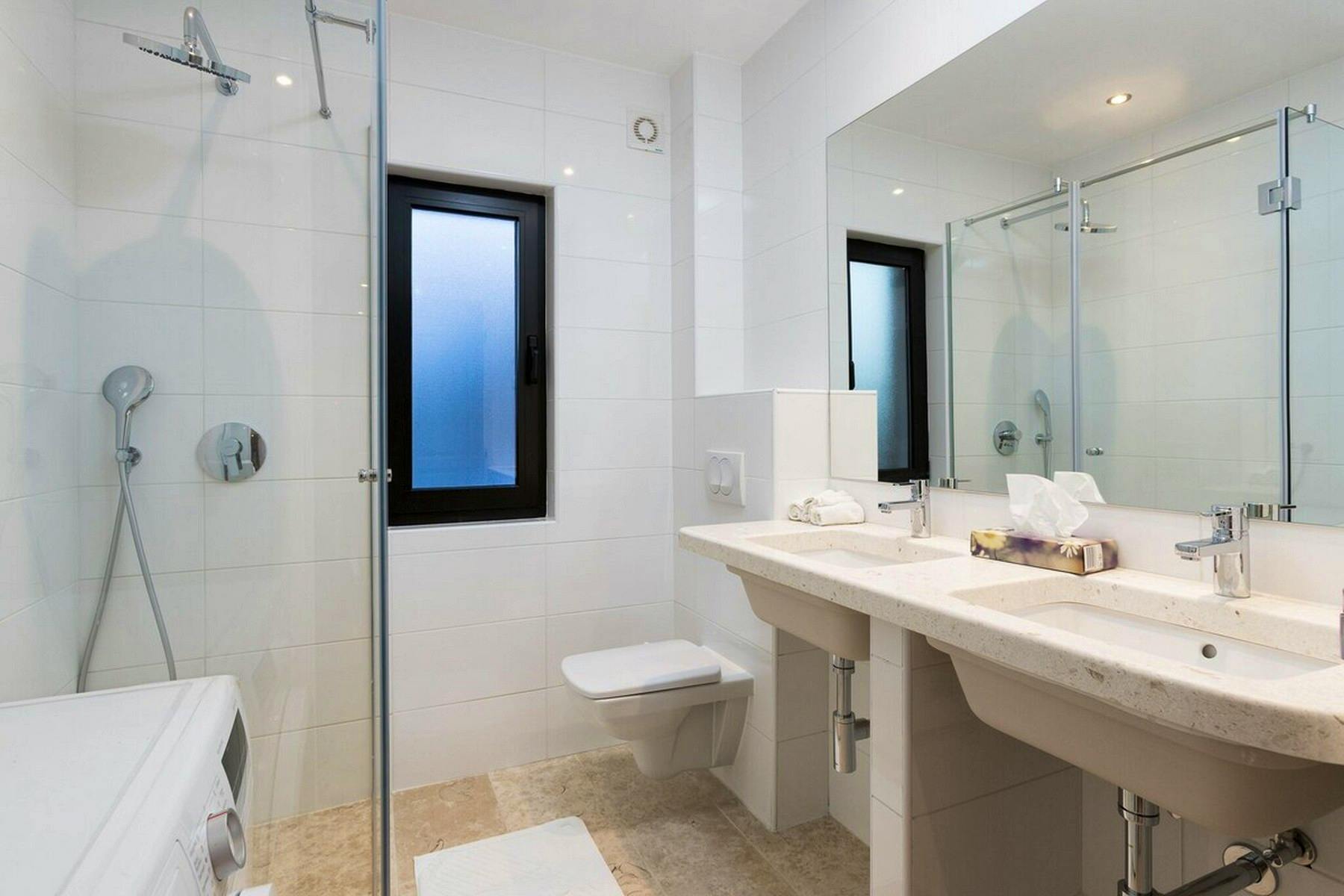 Bathroom with double sink and walk-in shower