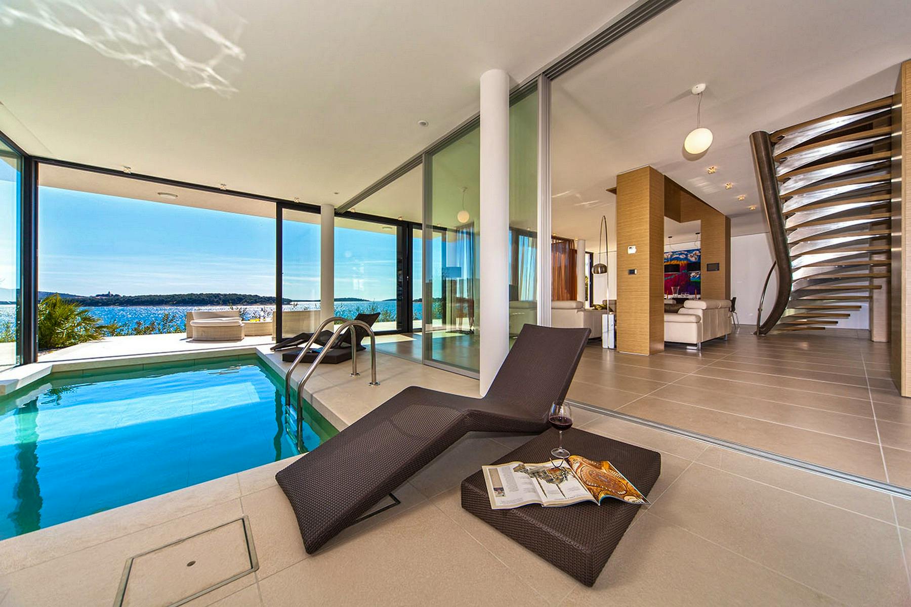 Inner swimming pool with loungers and spectacular sea view