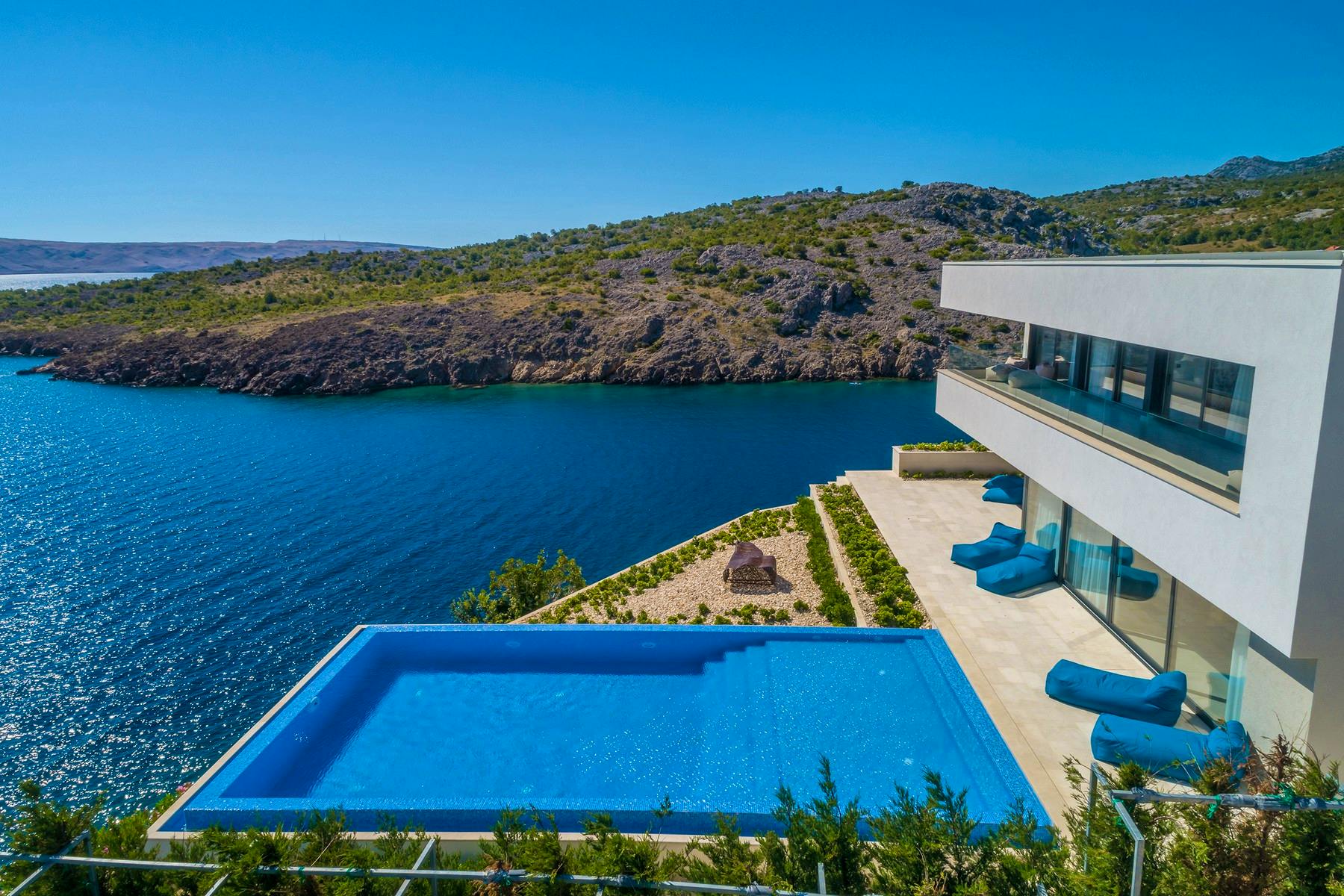Modern villa on a cliff with a swimming pool overlooking the sea 