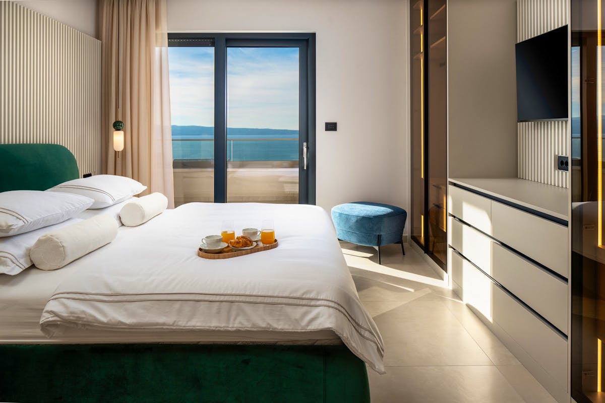 Elegant bedroom with balcony and open sea view