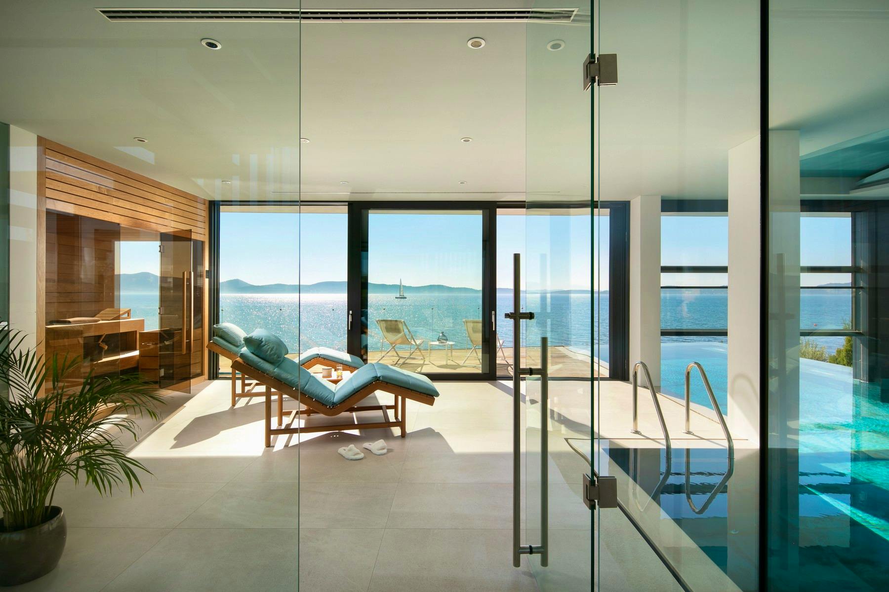 Wellness area with swimming pool and sauna overlooking the sea 