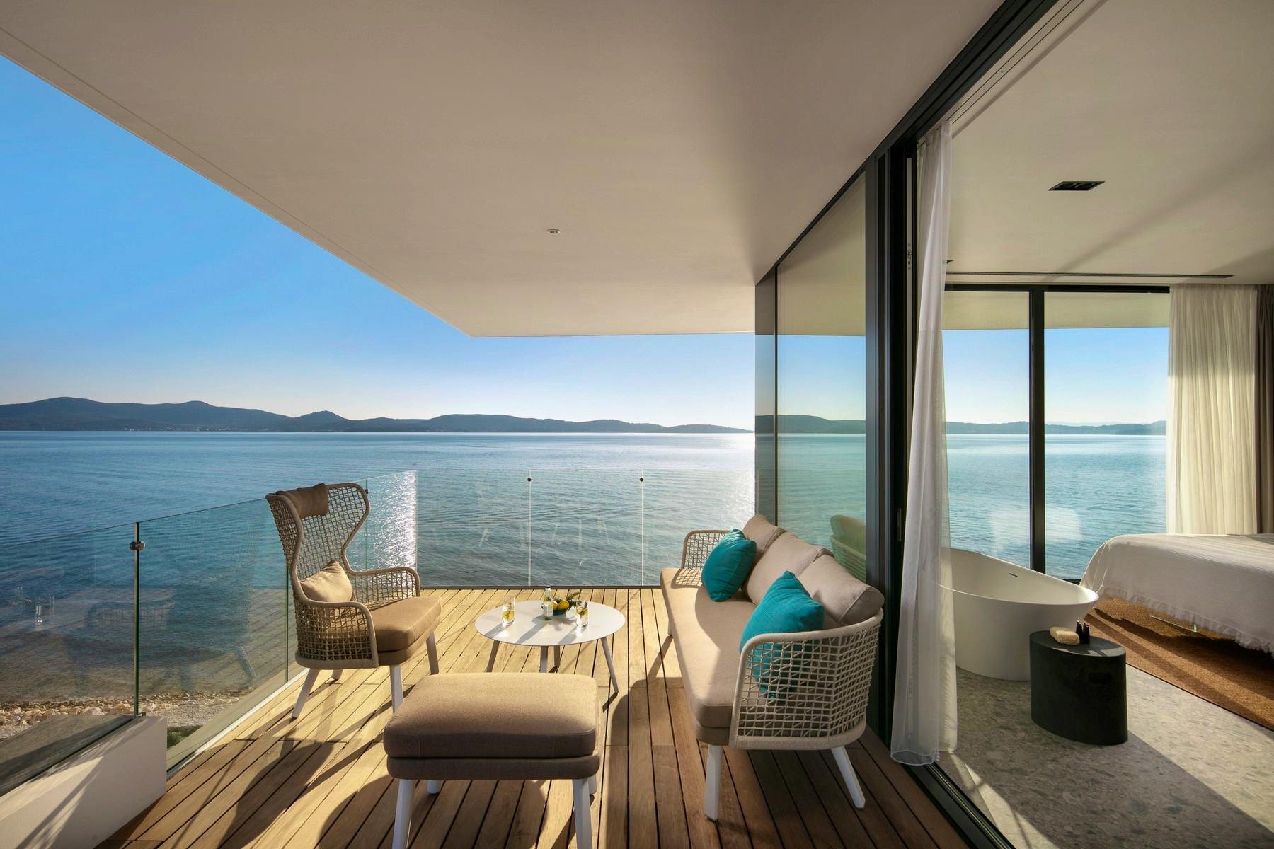 En-suite bedroom with a balcony and spectacular sea view