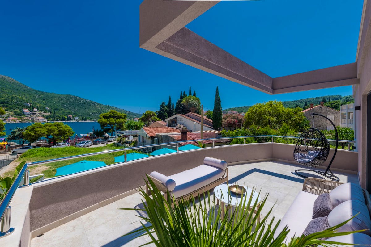 Spacious balcony with lounge area overlooking the sea