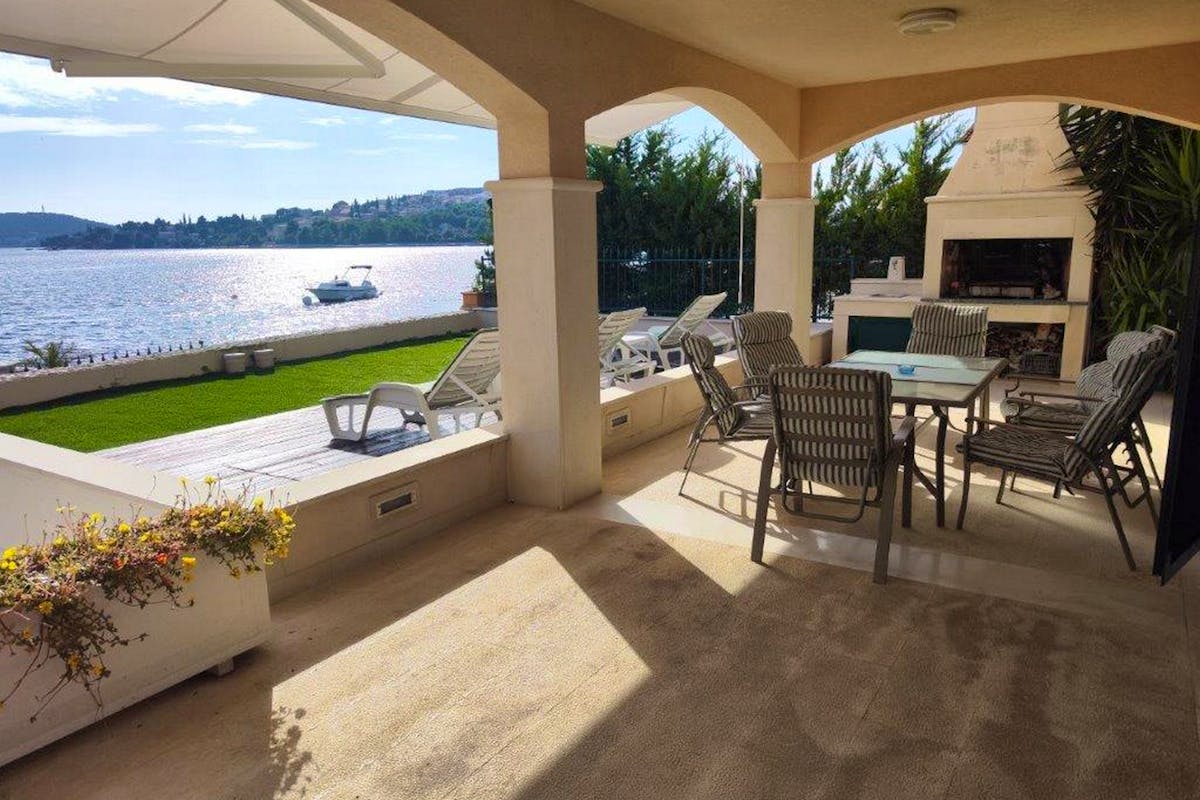 Spacious terrace with barbecue and dining area overlooking the sea