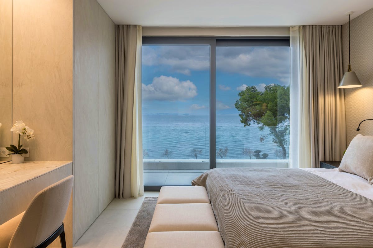 Luxurious ensuite bedroom with open sea view