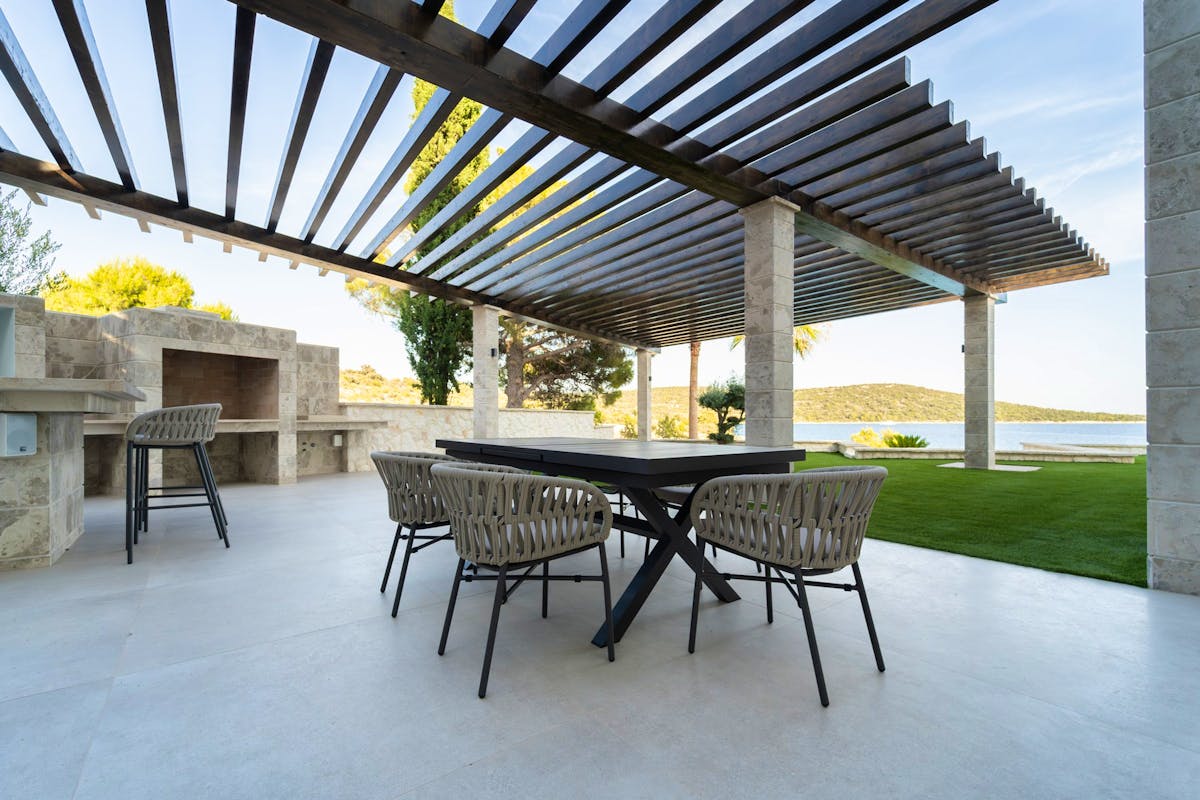 Spacious terrace with outdoor kitchen, barbecue and dining area